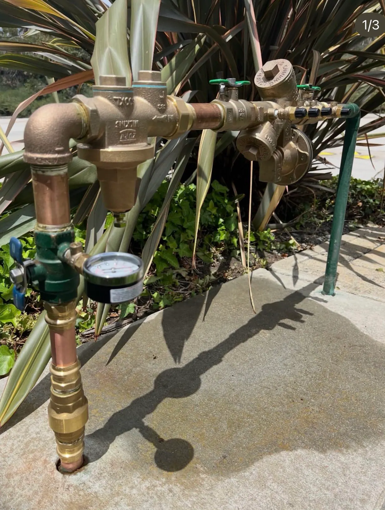 A backflow assembly connected to a pressure test gauge during field work
